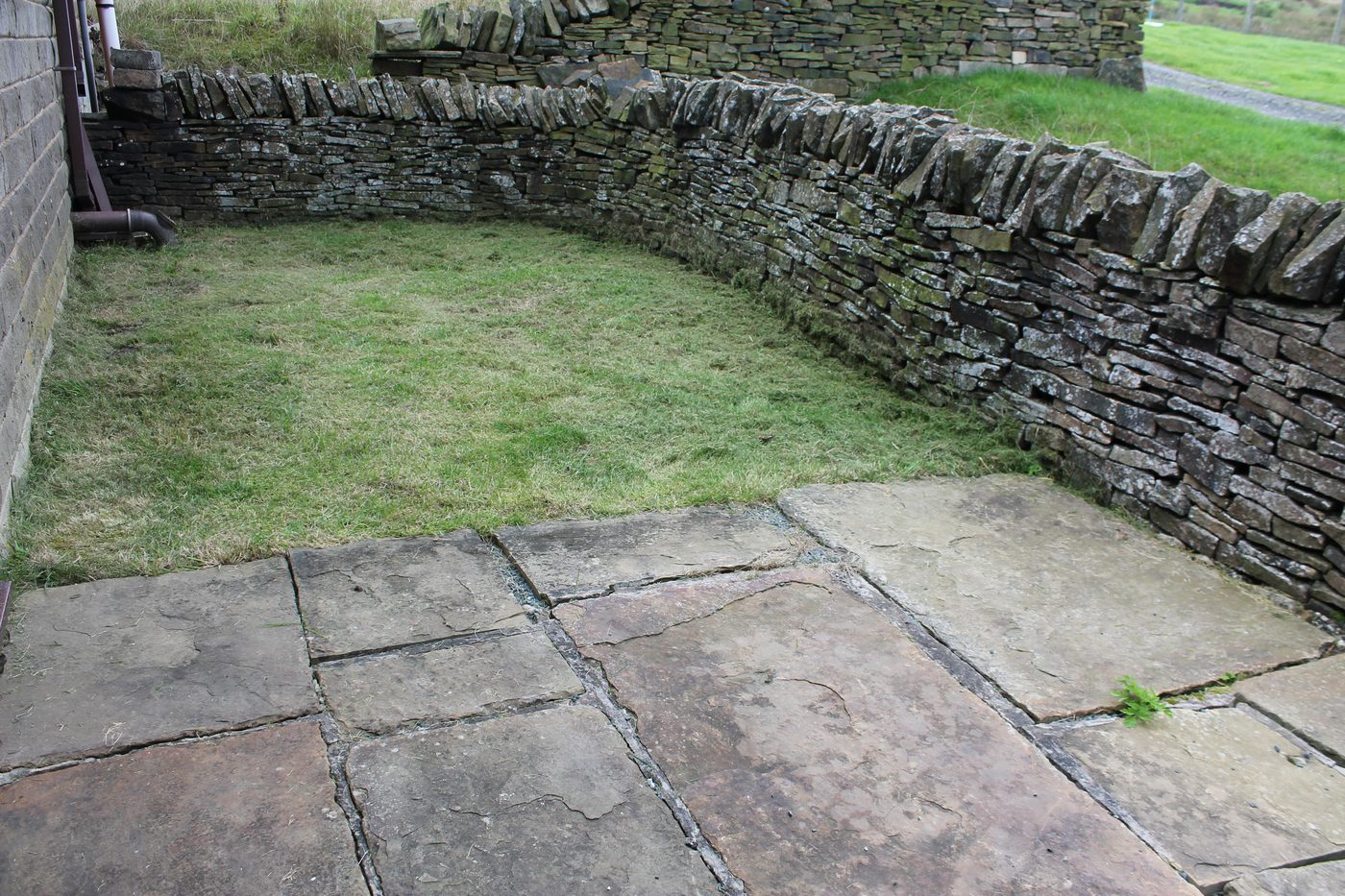 Private stone-flagged patio and lawn